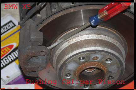 BMW X5 - Moving the caliper piston back into the caliper.