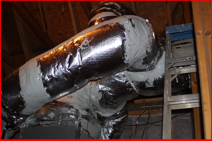 Shows duct work off the top of a Lennox HVAC blower